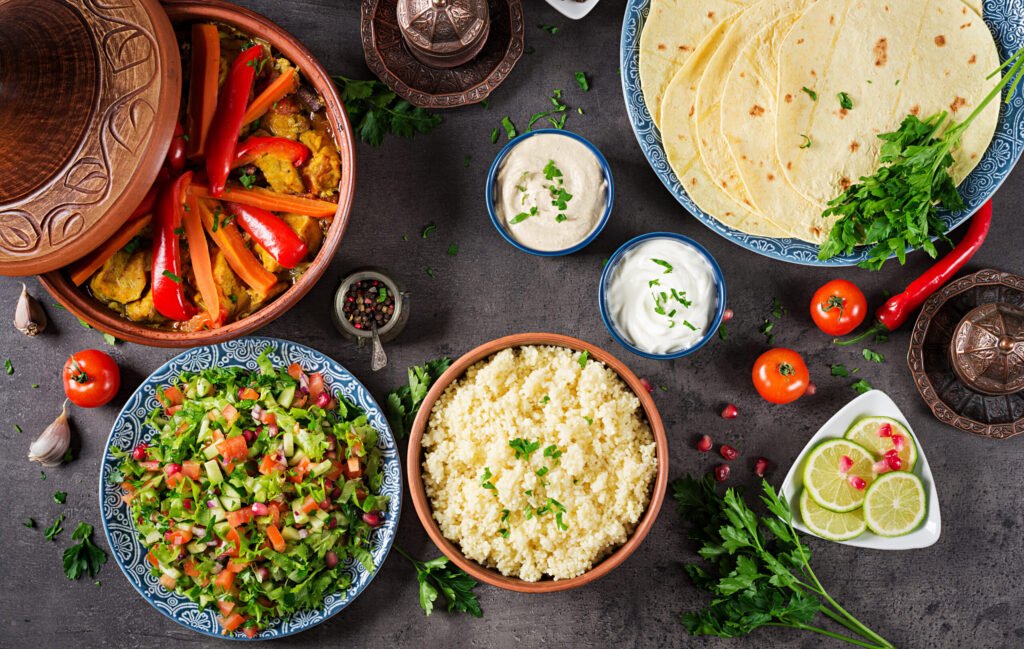 Traditional chicken Tagine dishes, couscous, fresh salad and vegetables. 