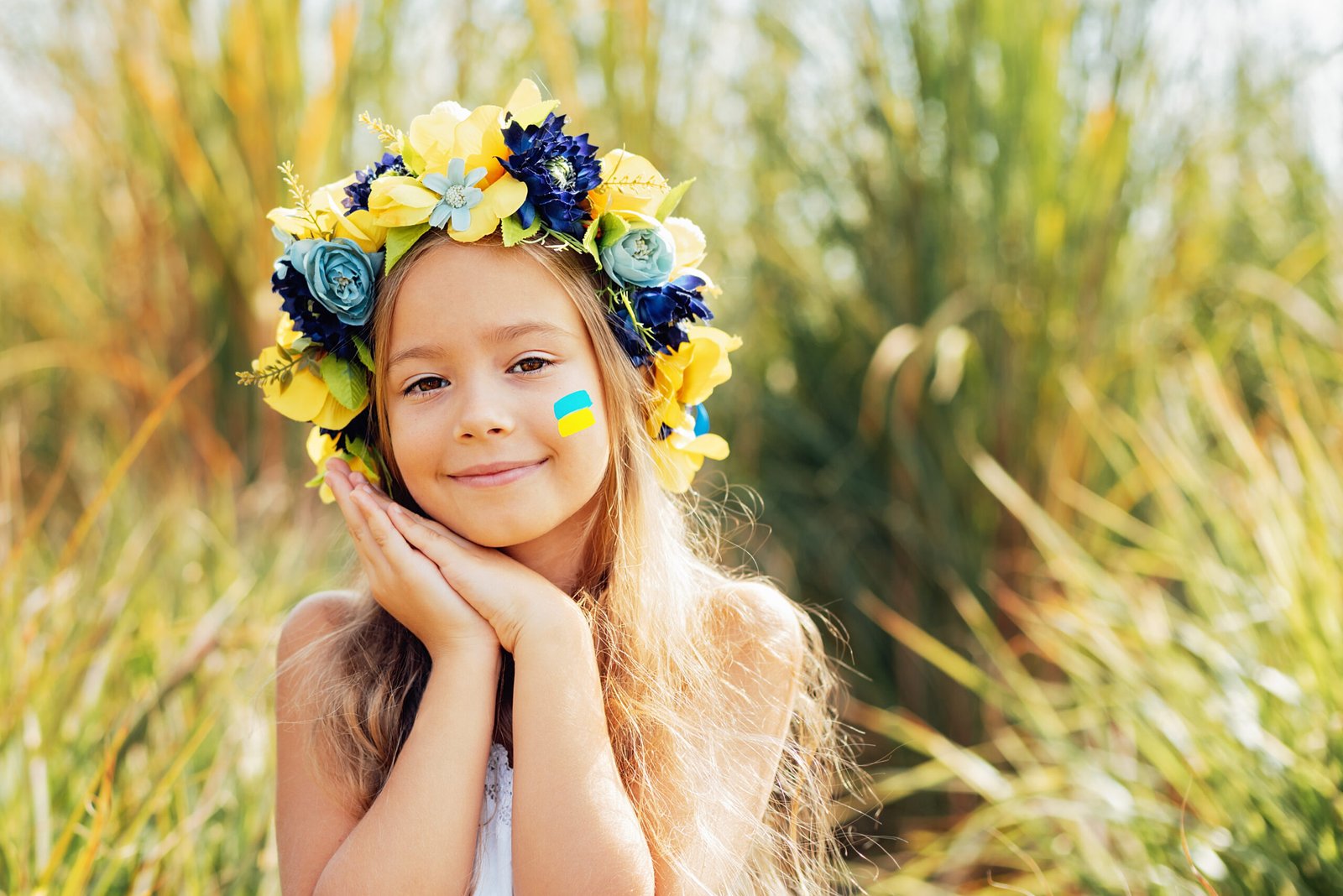 Ukrainian child girl with yellow and blue flag of Ukraine